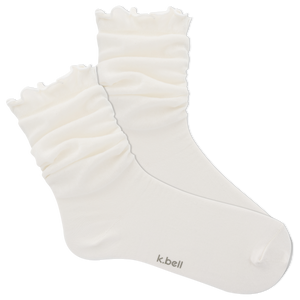 White ruffled sock with 'k.bell' branding on a white background