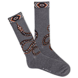 A pair of men's crew socks with a snake design, predominantly gray with orange and black accents, and a visible brand logo at the ankle. thumbnail