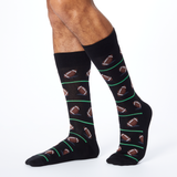 Front view of HOTSOX men's black crew socks on model with a repeat football pattern. thumbnail