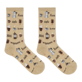 A pair of tan crew socks with coffee-related graphics such as cups and beans.
