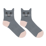 A pair of black ankle socks with a cat face design and blue accents on the heels and toes.